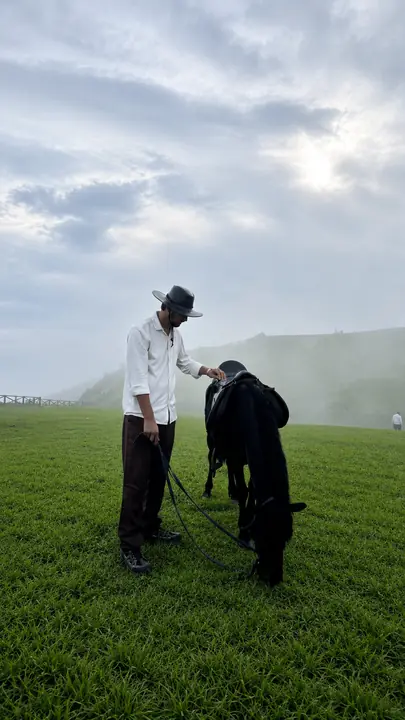 Horse and rider on a misty Meghalaya meadow